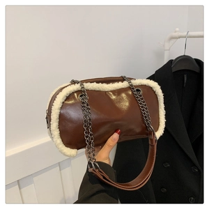 Detail view of the brown faux leather bag with white fuzzy faux fur trim and metal chain strap