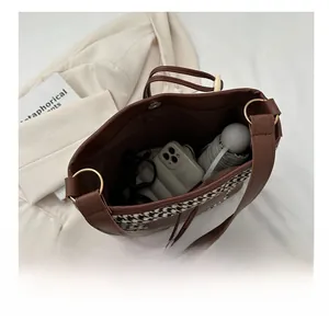 Spacious interior of plaid tote bag showing storage for phone, glasses and umbrella