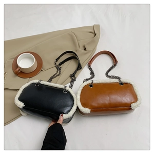 Detailed view of winter chain shoulder bags in black and caramel with white faux fur trim