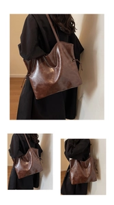 Detail of large dark brown tote bag in vintage faux leather with drawstring sides