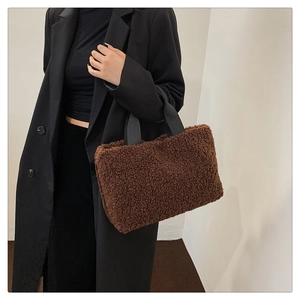 Close-up of dark brown plush fleece tote bag with black strap for autumn and winter outfits