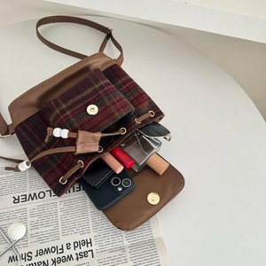 Interior view of wool plaid drawstring bucket bag showing storage for essentials