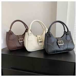 Three minimalist hobo bags in brown, beige, and black with silver buckles