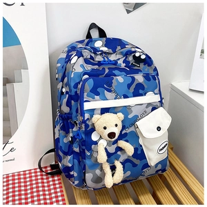 Blue camouflage school backpack featuring multiple pockets and a cute teddy bear pendant