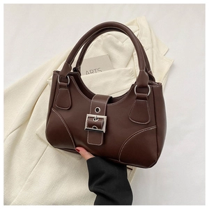 Detail of dark brown leather handbag featuring white contrast stitching and silver metal buckle