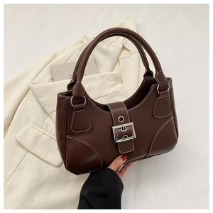 Detail of dark brown vintage handbag with contrast stitching and metal buckle decoration