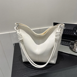 Minimalist white leather tote bag with knotted shoulder strap and silver hardware