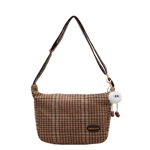Classic checkered fabric crossbody bag with brown leather strap and white plush ball charm
