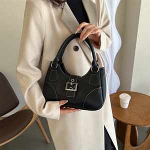 Vintage black leather handbag with white contrast stitching and silver metal buckle detail