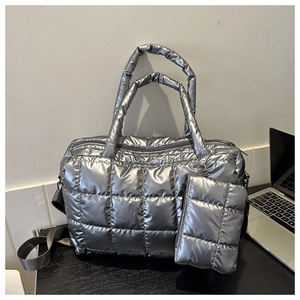 Close-up of silver quilted tote bag set with metal texture and matching mini pouch