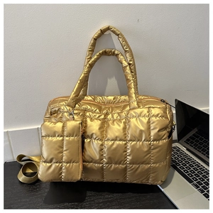 Detail of metallic gold quilted puffer tote bag with matching small zippered coin pouch