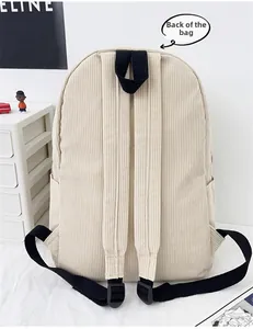 Detail view of the beige corduroy backpack back with adjustable black shoulder straps