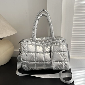 Silver quilted puffer tote bag with metallic finish, top handles and shoulder strap