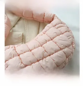 Detailed macro view of pink quilted puffer fabric texture and soft padded shoulder strap