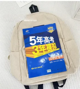 Beige corduroy backpack size comparison with an A4 book showing large storage capacity
