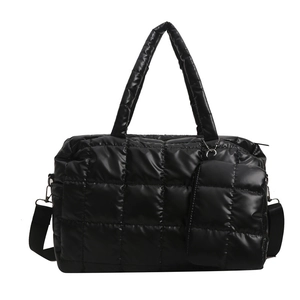 Fashionable black quilted puffer tote bag with matching mini pouch and adjustable strap