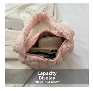 Detail view of pink quilted cloud bag showing internal capacity for phone and wallet
