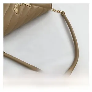 Detail of khaki quilted leather texture with gold metal buckle and leather chain strap
