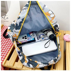 Interior view showing large capacity for laptop and daily items in the stylish print backpack