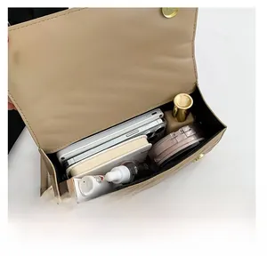 Quilted beige shoulder bag showing spacious interior with phone and cosmetics