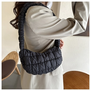 Close-up of black quilted cloud bag texture and crescent shape on shoulder