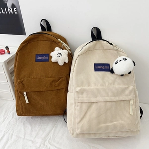 Minimalist corduroy backpacks in brown and beige colors with plush pendants for students