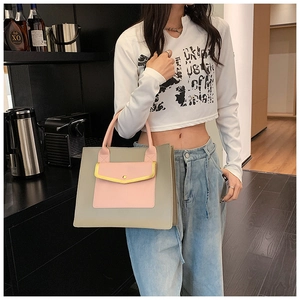 Women's color block tote bag in grey-green and pink with adjustable shoulder strap