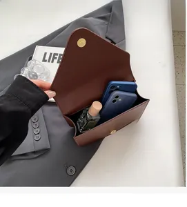 Interior view of small square stone embossed bag showing spacious capacity for two phones