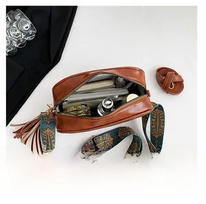 Interior view of brown retro crossbody bag with tassel and spacious storage capacity