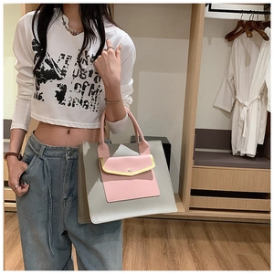 Detail of grey and pink tote bag showing the exterior snap pocket and color contrast
