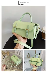 Detail view of mint green crossbody bag featuring gold hardware and adjustable strap