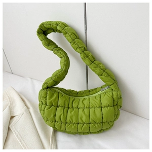 Detail of the bright green quilted puffer bag with textured bubble fabric and wide strap