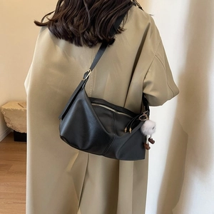 Minimalist black lychee texture half-moon hobo bag with cute white plush doll pendant