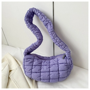 Detailed view of purple quilted crescent bag with puffer texture and thick shoulder strap
