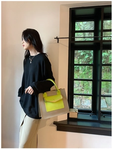 Detail of grey and neon green contrast tote bag with functional front flap pocket