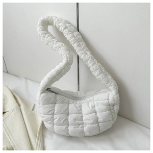 Detail of white quilted puffy shoulder bag with ruched fabric and zipper closure
