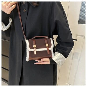 Detail of vintage faux fur patchwork shoulder bag with golden buckles and leather strap