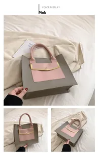 Detail of grey tote bag featuring pink snap pocket with elegant gold metal trim bar