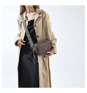 Brown vintage leather crossbody bag featuring an embroidered wide shoulder strap and fringe