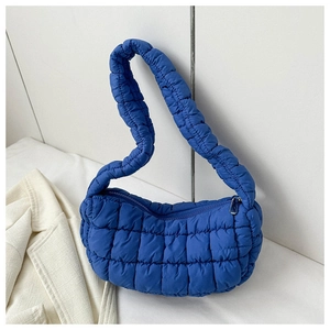 Blue quilted puffer shoulder bag with pleated strap and silver zipper closure detail