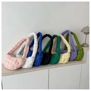 Detailed close-up showing a variety of colorful quilted shoulder bags in soft nylon fabric