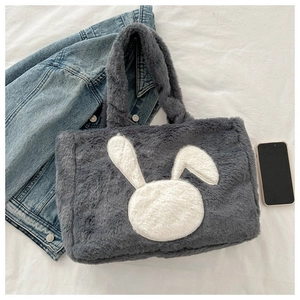 Détail du sac cabas gris en peluche avec broderie lapin et texture en fausse fourrure