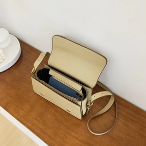 Minimalist beige leather crossbody square bag with flap closure and adjustable strap