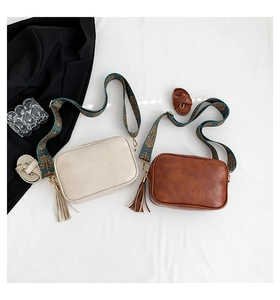 Detail of vintage crossbody bags in beige and brown with bohemian jacquard straps