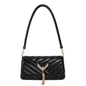 Classic black quilted shoulder bag with gold V-shape hardware and tassel on white background