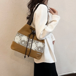 Minimalist canvas bucket bag with vintage lace patterns and a drawstring closure