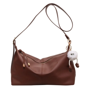 Brown lychee leather crescent tote bag with adjustable strap and plush pendant charm