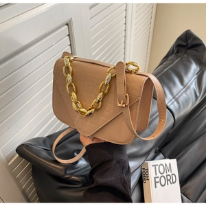 Close-up of beige stone embossed square bag with gold chain strap and leather finish