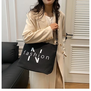 Large capacity black canvas tote bag for women, casual single shoulder commuter handbag.