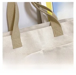Gros plan sur les coutures en X et la texture du tissu d'un sac cabas en toile beige